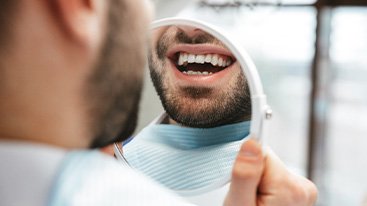 Patient looking at smile in reflection