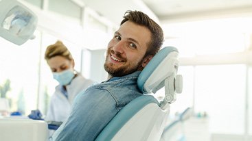 Man smiling while sitting in treatment chair