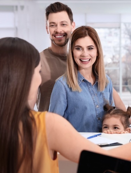 Family checking in at dental office