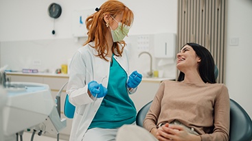 Patient smiling at dentist in treatment chair