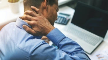 Man holding his neck in pain