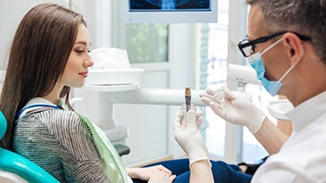 Implant dentist in Hamden explaining implant to woman patient