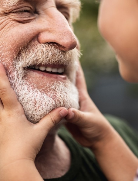 Man with healthy smile after dental implant treatment