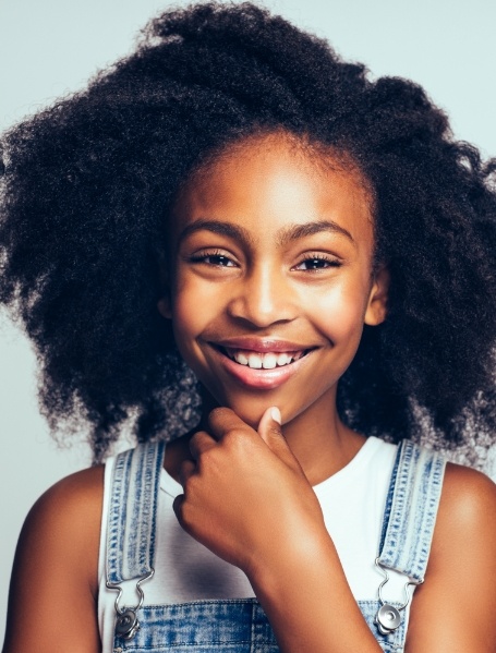 Young girl with healthy smile after dental sealants