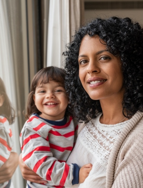 Mother and child smiling after pulp therapy