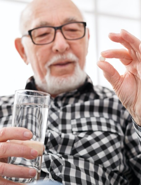 Man taking oral conscious sedation dentistry pill