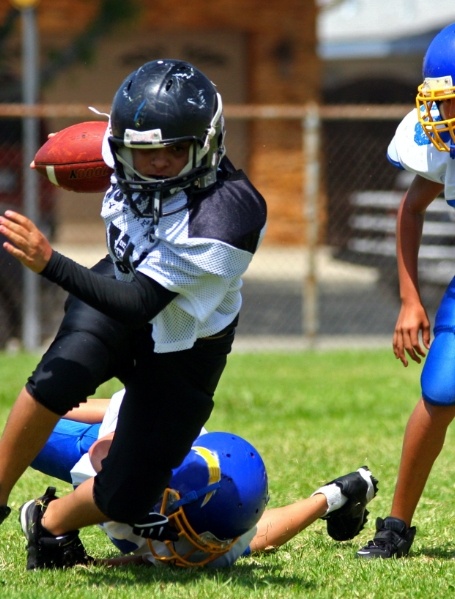 Young athletes with sportsguards playing football