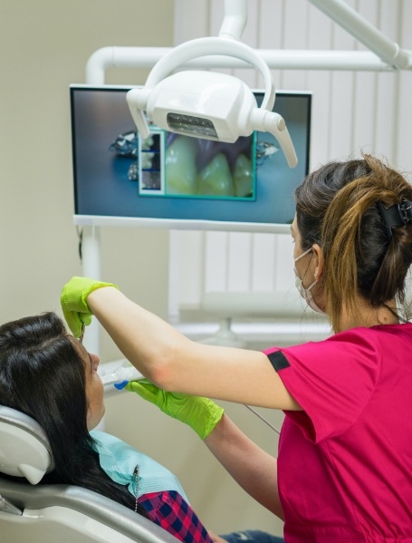 Dental team member capturing smile images using intraoral camera