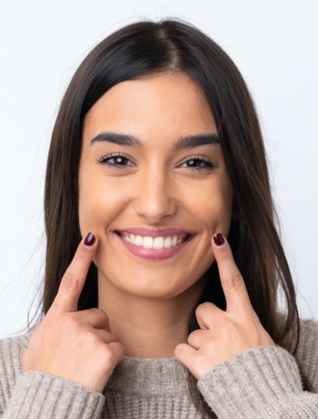 Woman with porcelain veneers sharing her smile