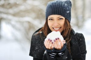 Woman smiling with snow.