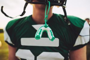 Football palyer with mouthguard
