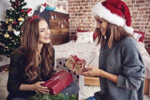 women exchanging holiday gifts