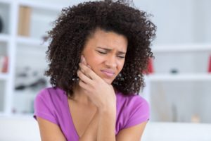 woman with toothache who needs emergency dentist in Hamden