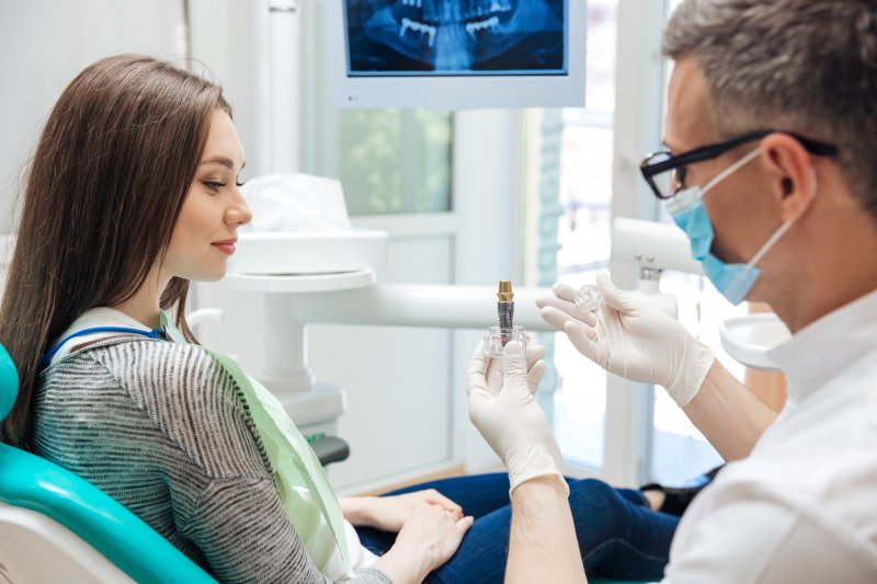 Dentist explaining dental implants in Hamden