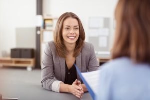 woman with a white smile at a job interview 