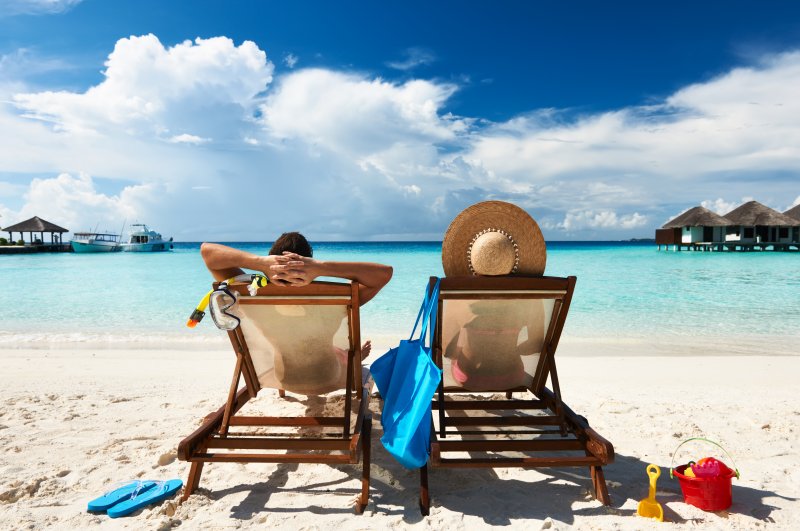 Couple relaxing on summer vacation at the beach 