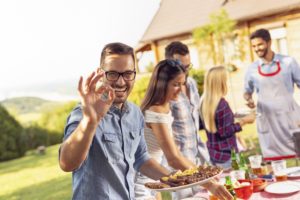 Man with dental implants enjoying summer foods