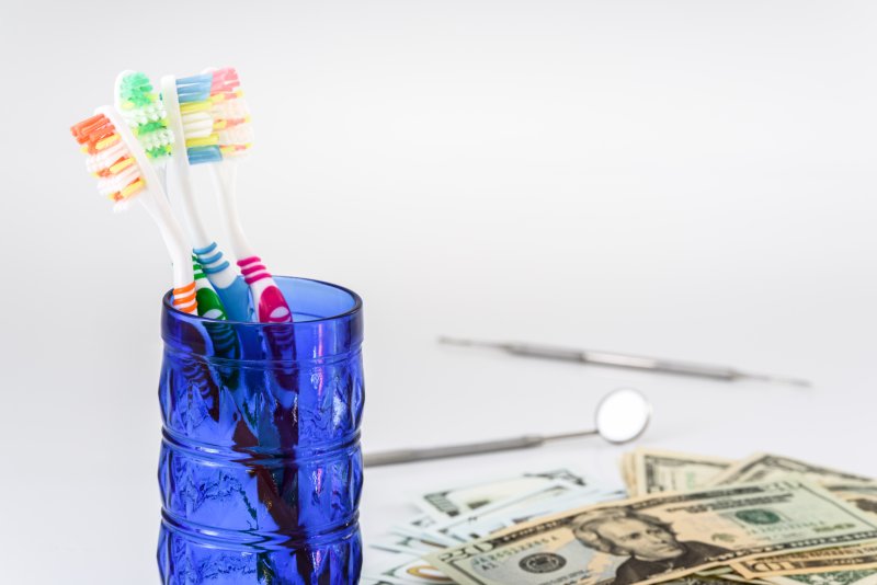 toothbrushes sitting next to money