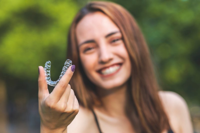 Person holding Invisalign aligning tray