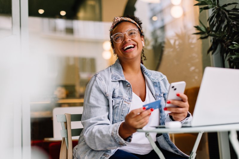 A woman with good dental health laughing in a cafe