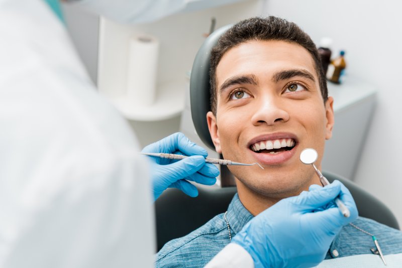 A young man getting a dental checkup early in the year