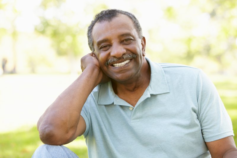 Older man smiling with Invisalign